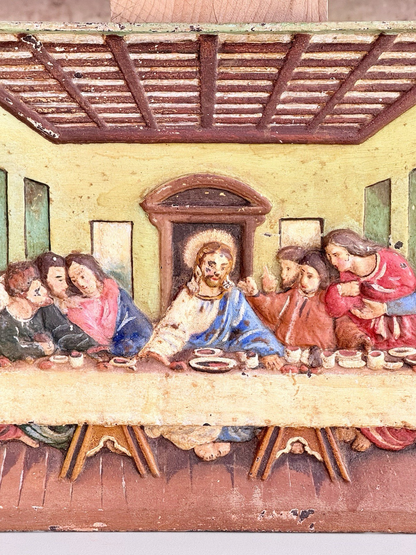 Close-up of Christ at the centre of the Last Supper relief plaque