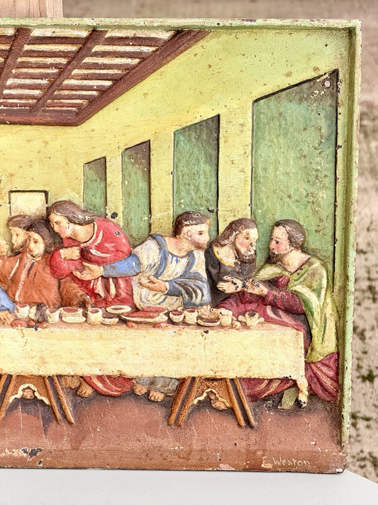 Close-up of painted apostles on the left of the Last Supper cast iron plaque
