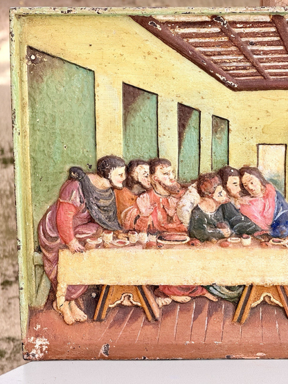 Close-up of painted apostles on the right of the cast iron plaque