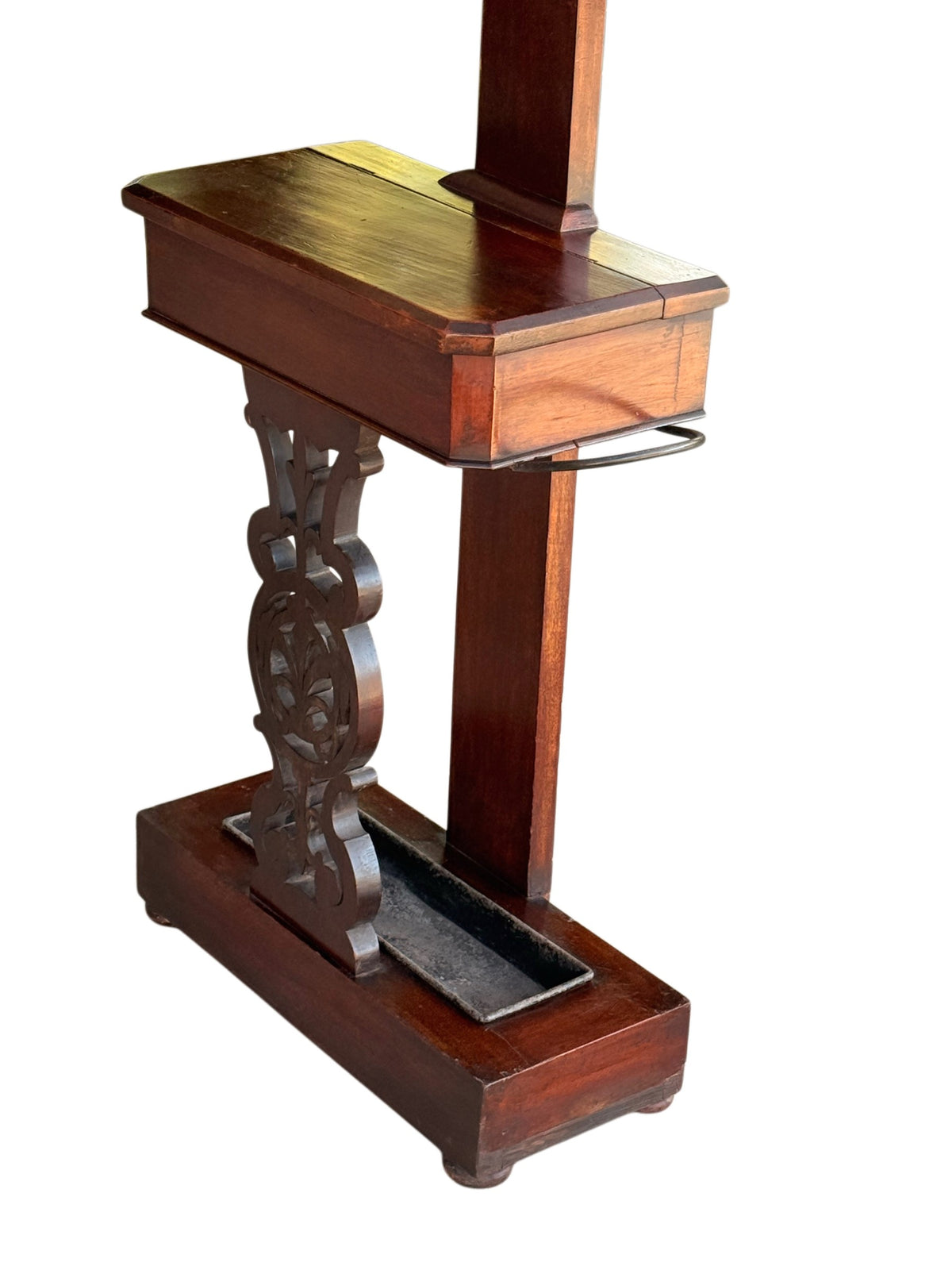 Lower section of the Victorian mahogany hall stand showing the glove box, fretwork support and plinth base