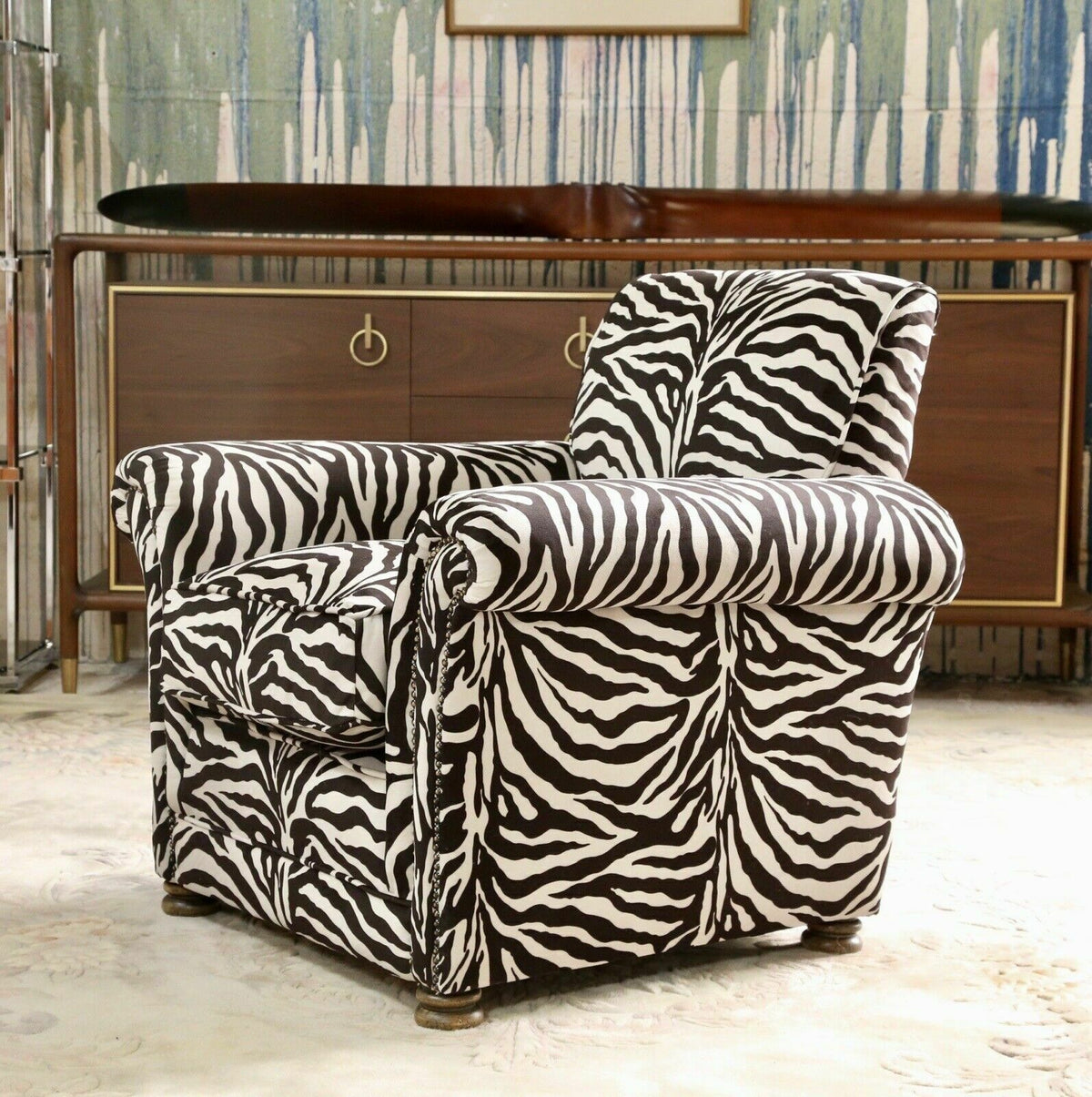 Vintage French zebra print club chair with low back, shaped arms and long seat cushion on turned legs