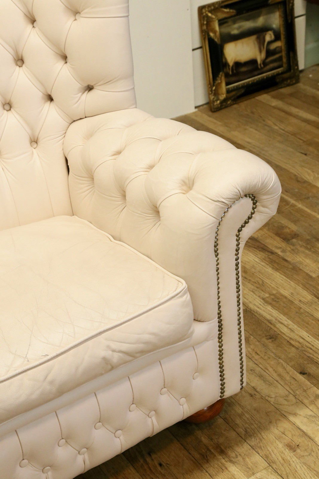 Close-up of seat cushion and buttoned rolled arm